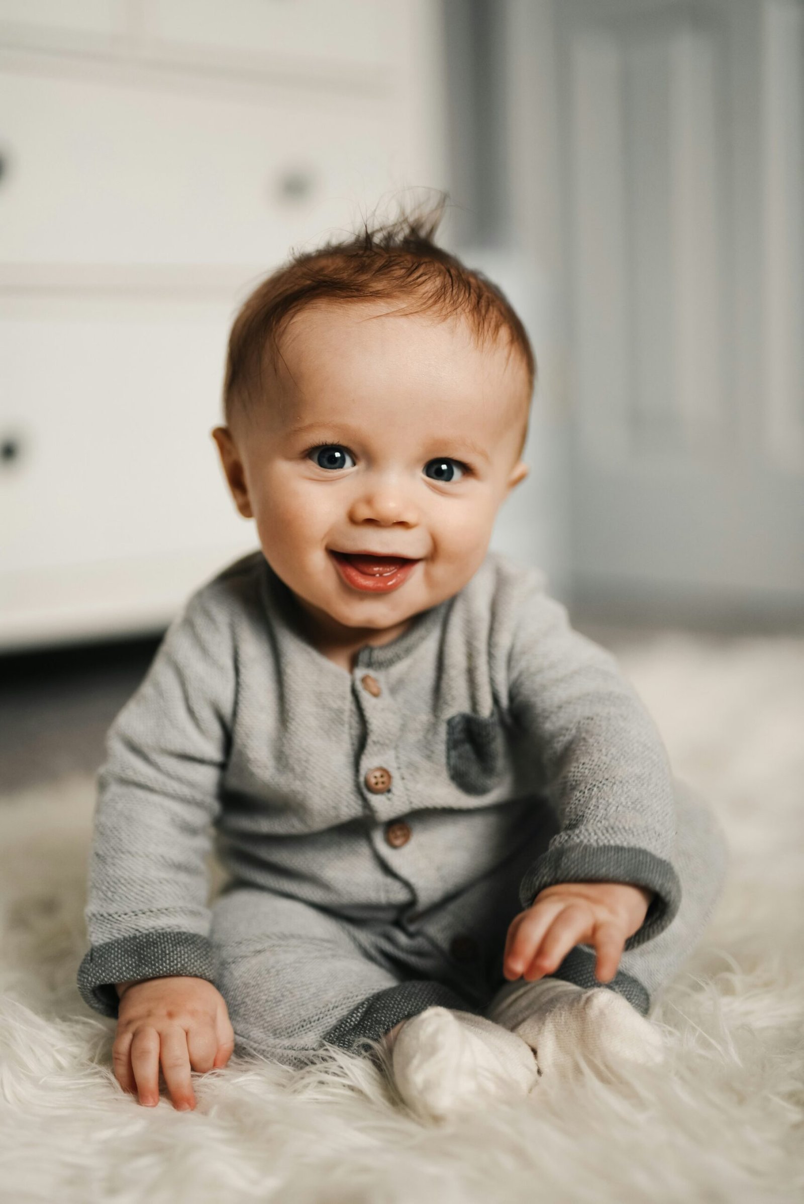 Baby wearing a soft romper while sitting indoors