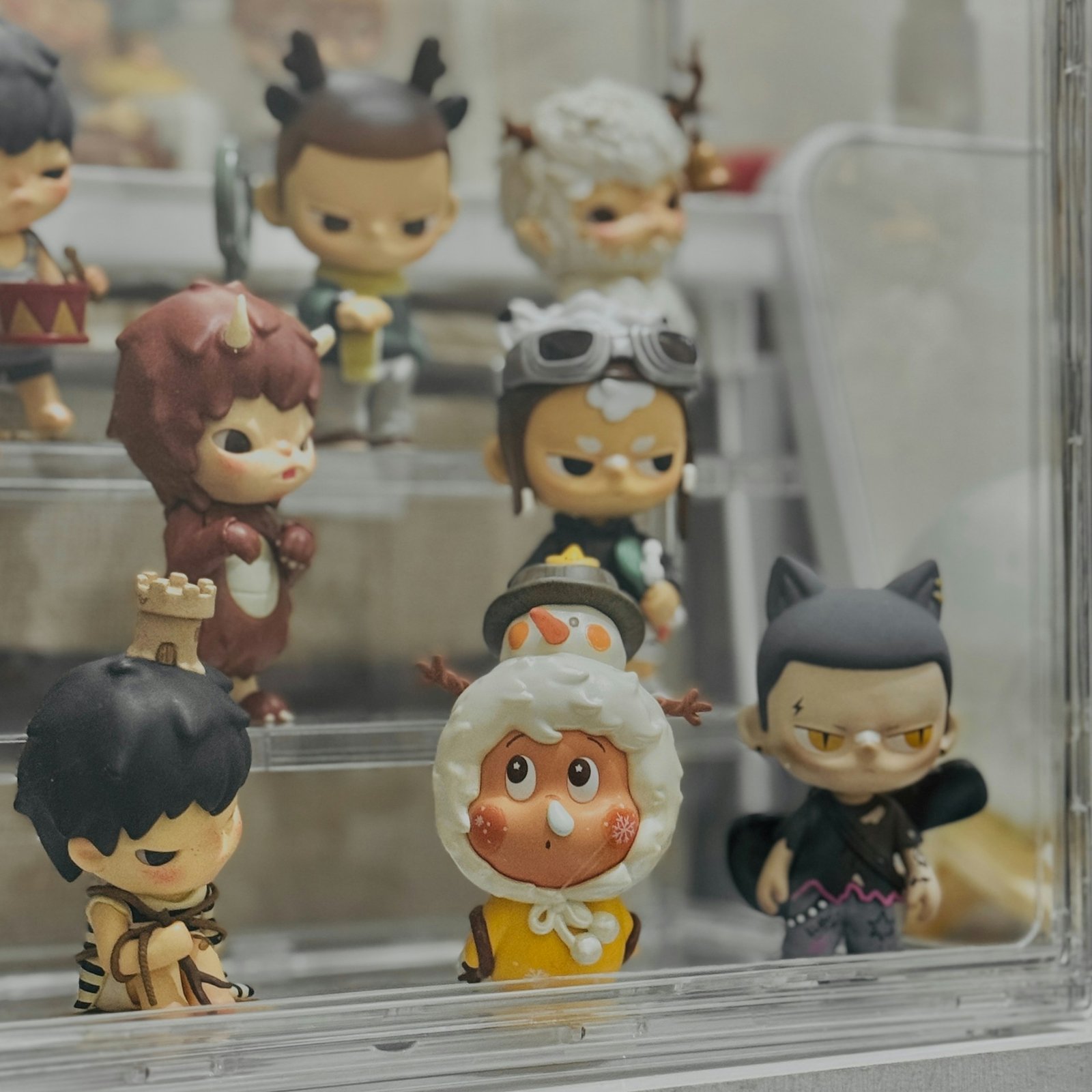 Collectible figurines displayed together in a glass case